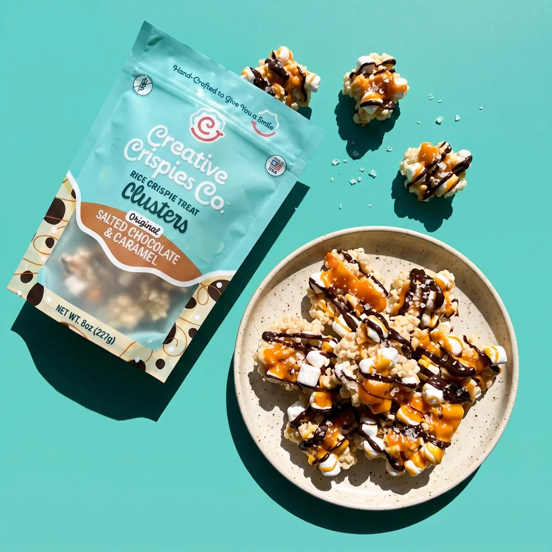 Dark Chocolate, Caramel & Sea Salt Clusters bag with a plate of clusters, shot from above